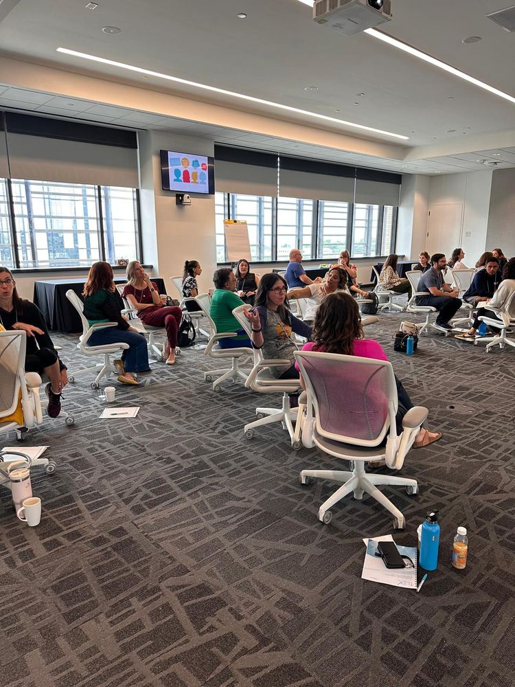 A group seated in a circle during a guided practice
