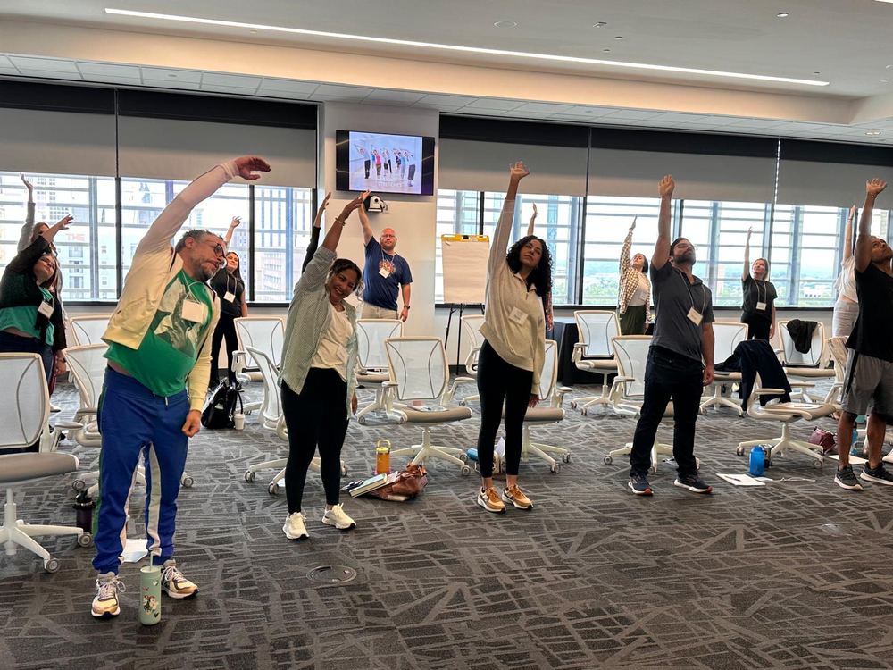 Participants standing and stretching during a session